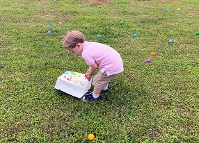 child looks for eggs
